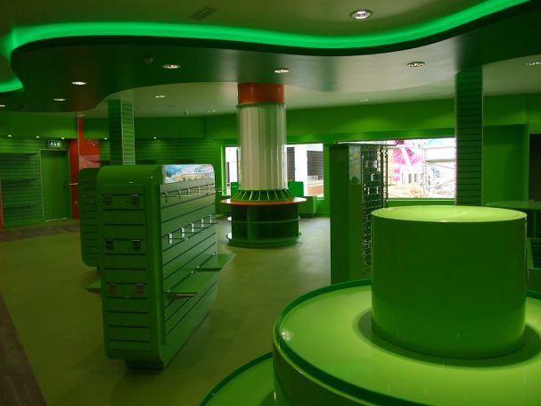 Interior of a brightly lit space with green decor and circular features.